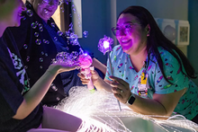 lizeth deleon uses distractions with a patient getting a vaccine.