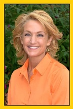 jackie nau photo - blonde hair and orange shirt in front of trees