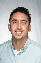 picture of Mark Thomas, dark hair wearing blue shirt