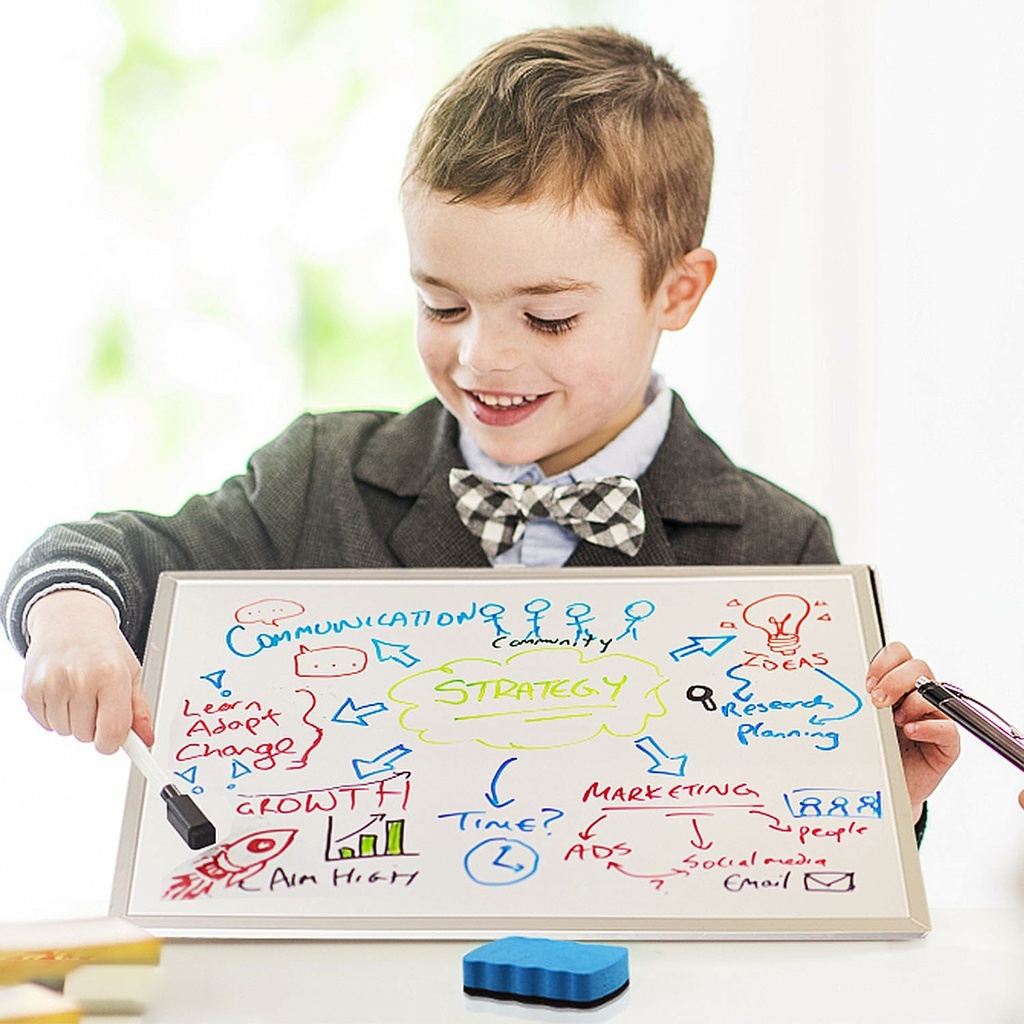 little boy pointing to white board