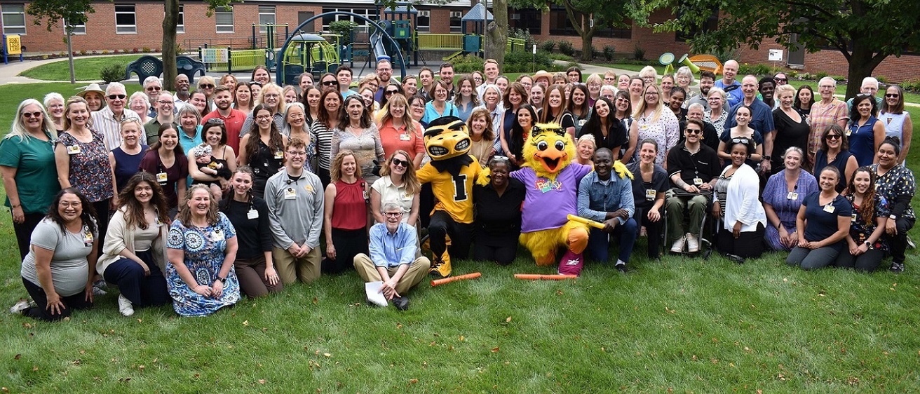 CDD 75th anniversary event group photo in the courtyard - alternate image