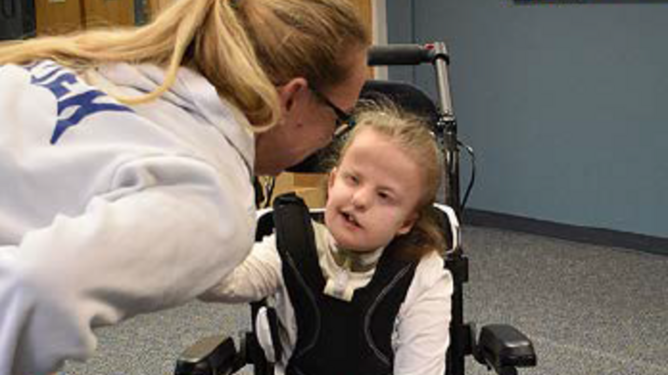 mother and little girl in a wheelchair at CDD wheelchair clinic